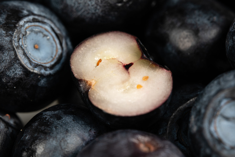 A macro lens shot of a cut open blueberry.