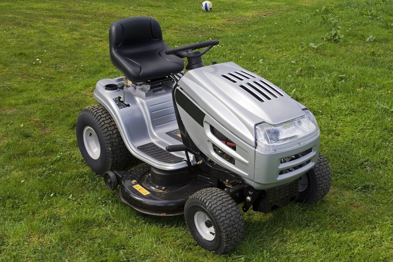 Silver riding lawn mower sitting on lawn