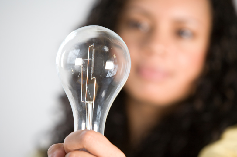Woman holding light bulb