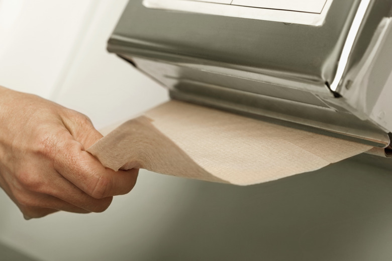 Healthcare worker pulling out paper towel in hospital