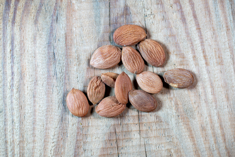 Peach seeds on a wooden table.