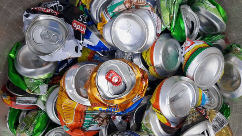 Crushed aluminum cans sit in a bin.