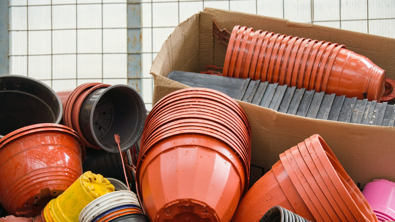 Stacks of plastic planters are piled on top of one another.