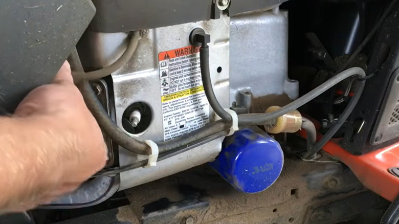 A man prepares to change a spark plug.