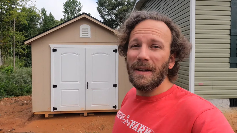 Man stands in front of his Gorilla elite shed.