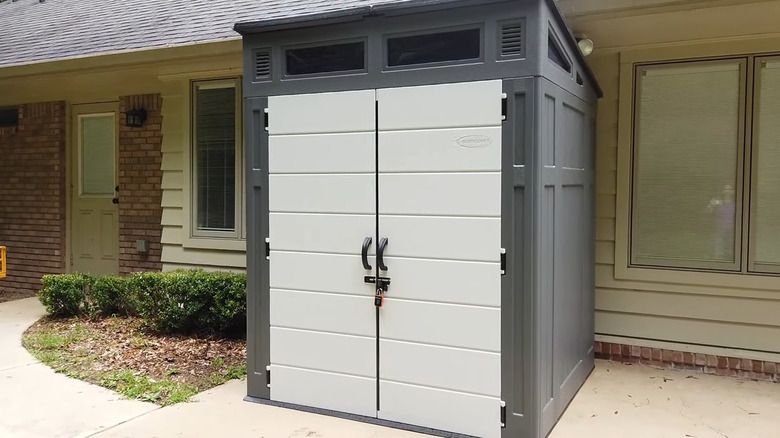 A Suncast 6x5 shed sits near a house.