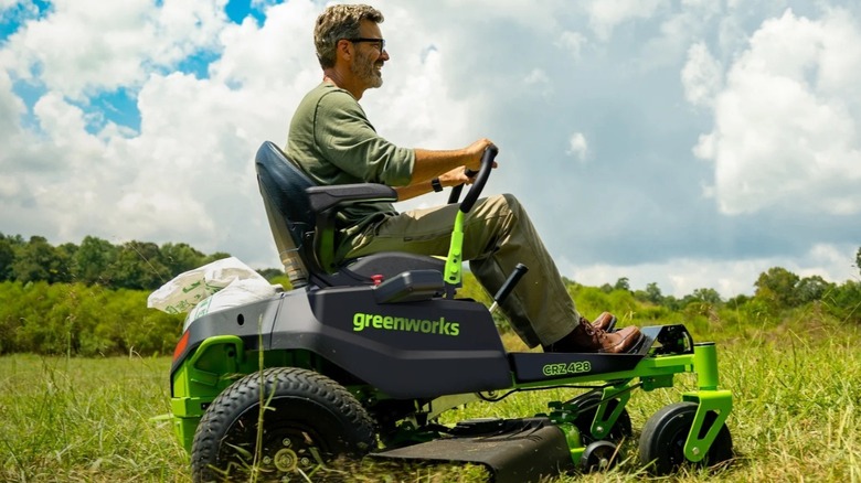 Man rides on the Greenworks riding lawn mower.