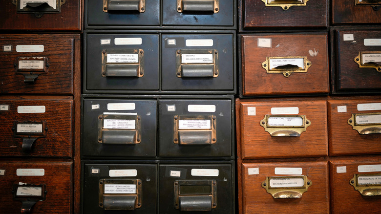 rows of old filing cabinets in wood and black colors
