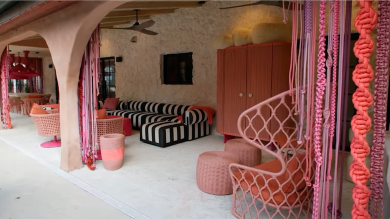 Colorful macrame curtains made by Bromstad frame a patio space.