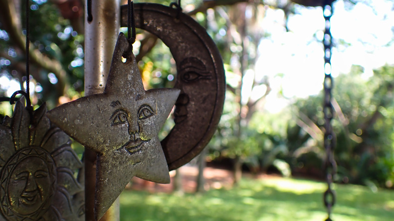 a wind chime focuses in on a star and a moon on a wind chime