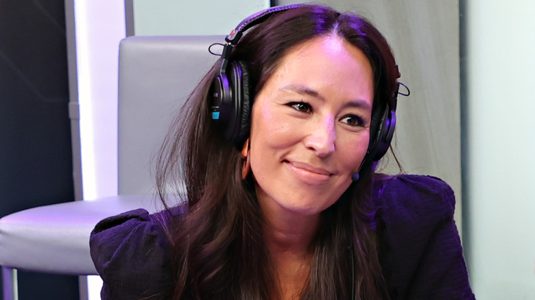 Joanna Gaines talks on a podcast.