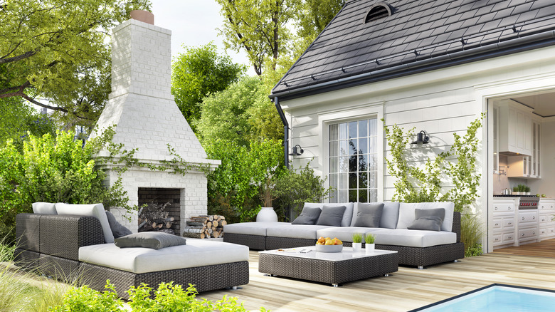 A patio offers comfortable seating and a fireplace.