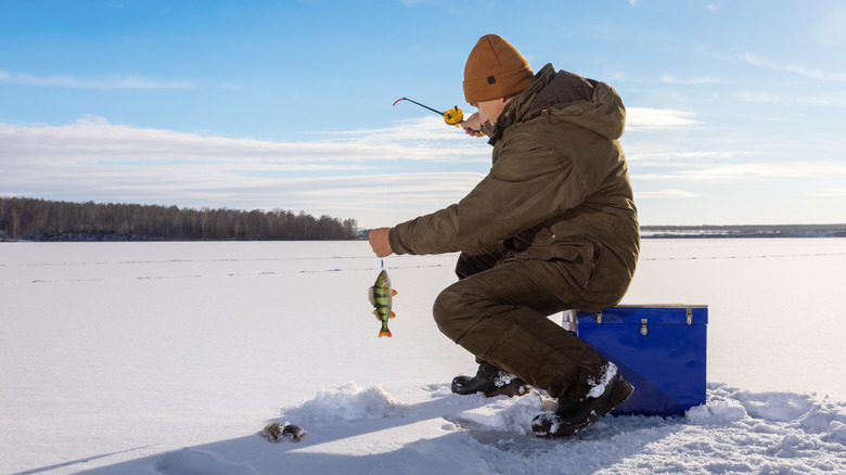 A man fishes on a frozen lake.