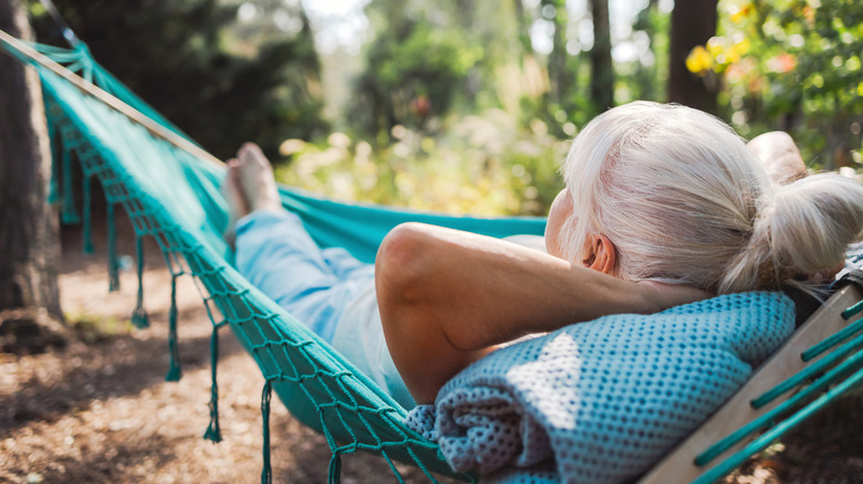 A woman hangs in a hammock.