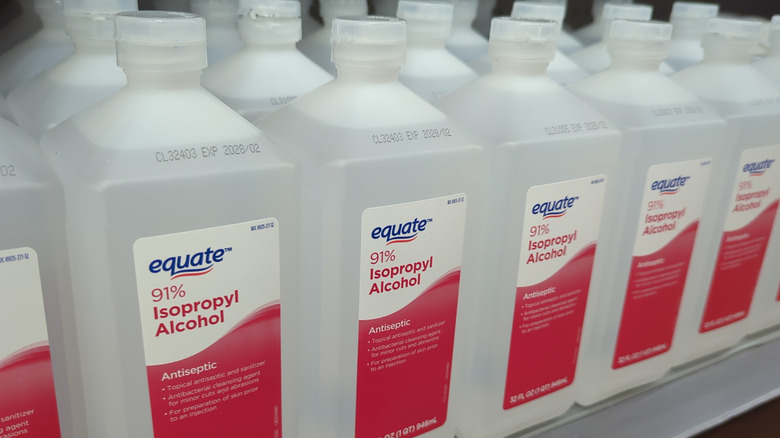 Rows of rubbing alcohol sits on a shelf at a store.