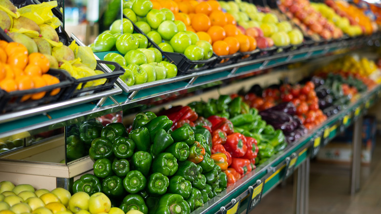 Fruits and vegetables fill grocery store shelves.